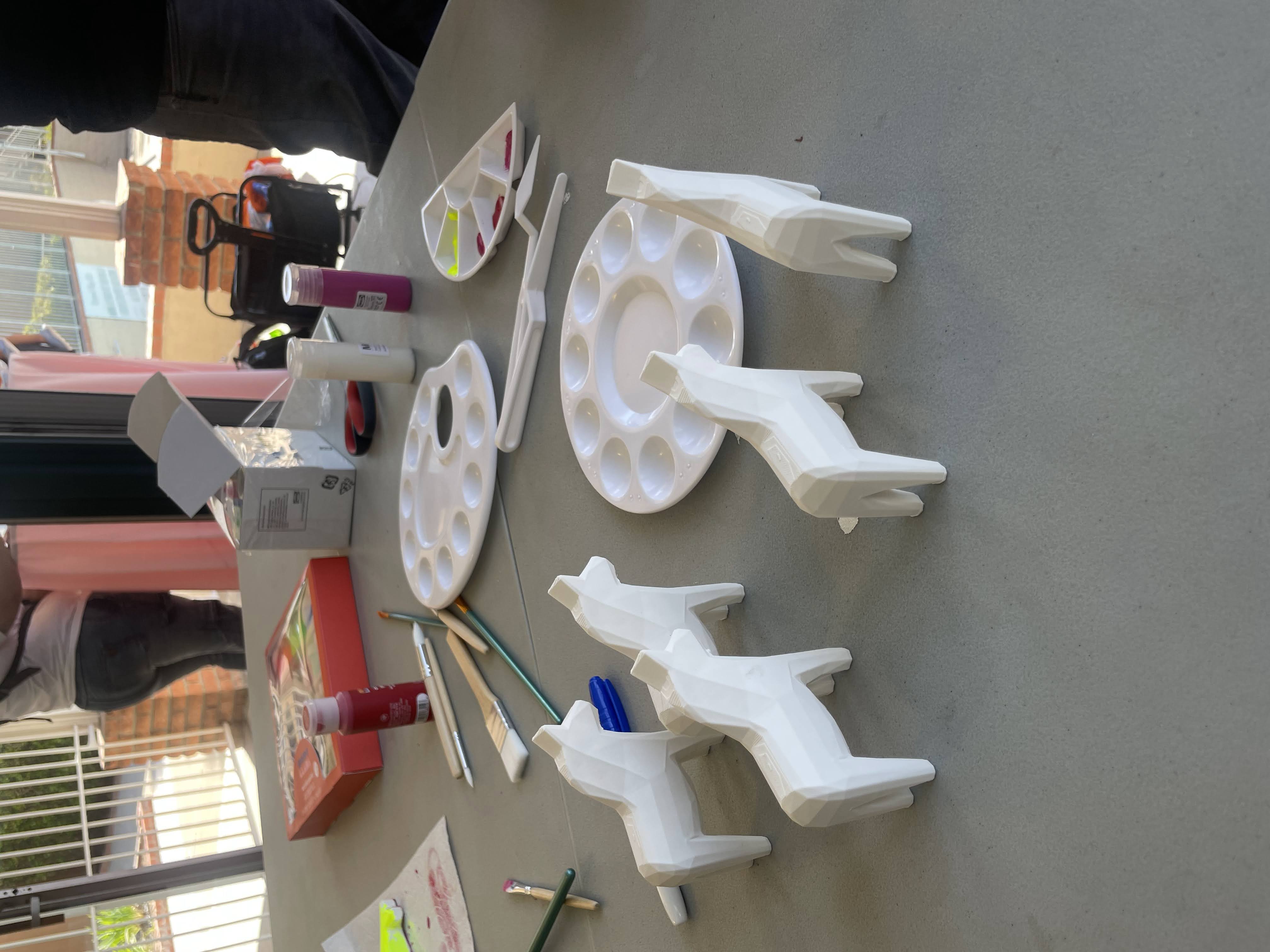 3D printed horses at a community painting event