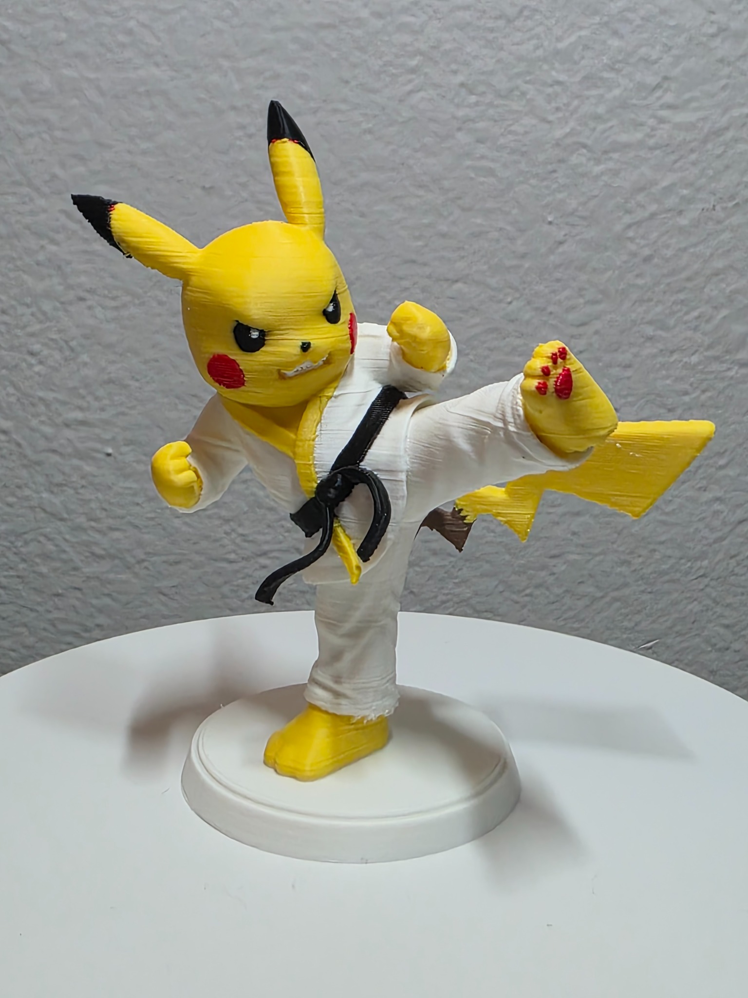 Yellow character in a taekwondo uniform performing a high kick